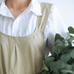 Cross Back Cotton Apron khaki 100% washed cotton no tie slip on chef florist apron model neckline close-up view