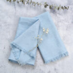 light blue cotton fringe napkin with eucalyptus decor