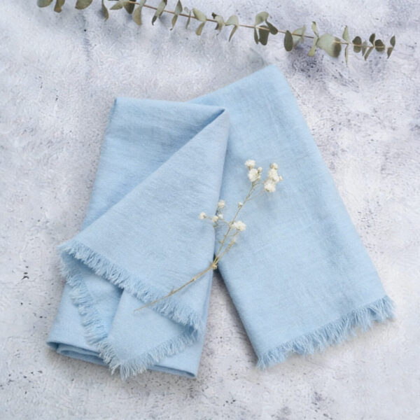 light blue cotton fringe napkin with eucalyptus decor