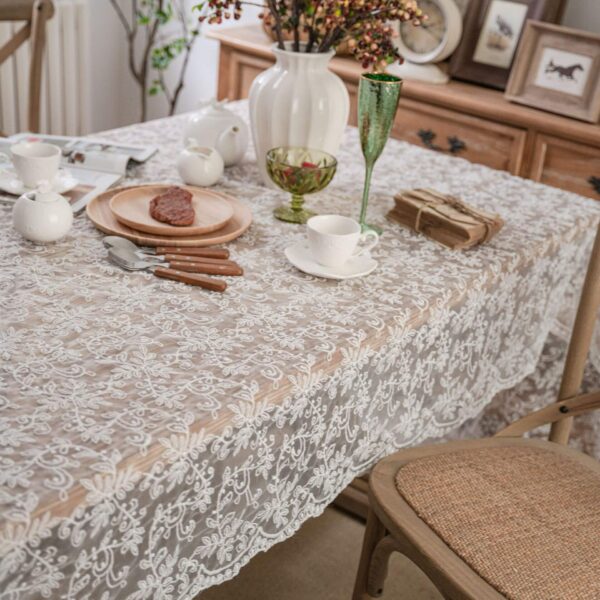 white lace embroidered tablecloth with dot leaf pattern styled with tableware