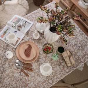 white lace embroidered tablecloth detail view with tableware