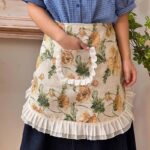 woman wearing floral half apron while cooking