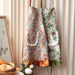 Mia Floral vintage apron with ruffle trim, polyester kitchen apron in cozy kitchen setting