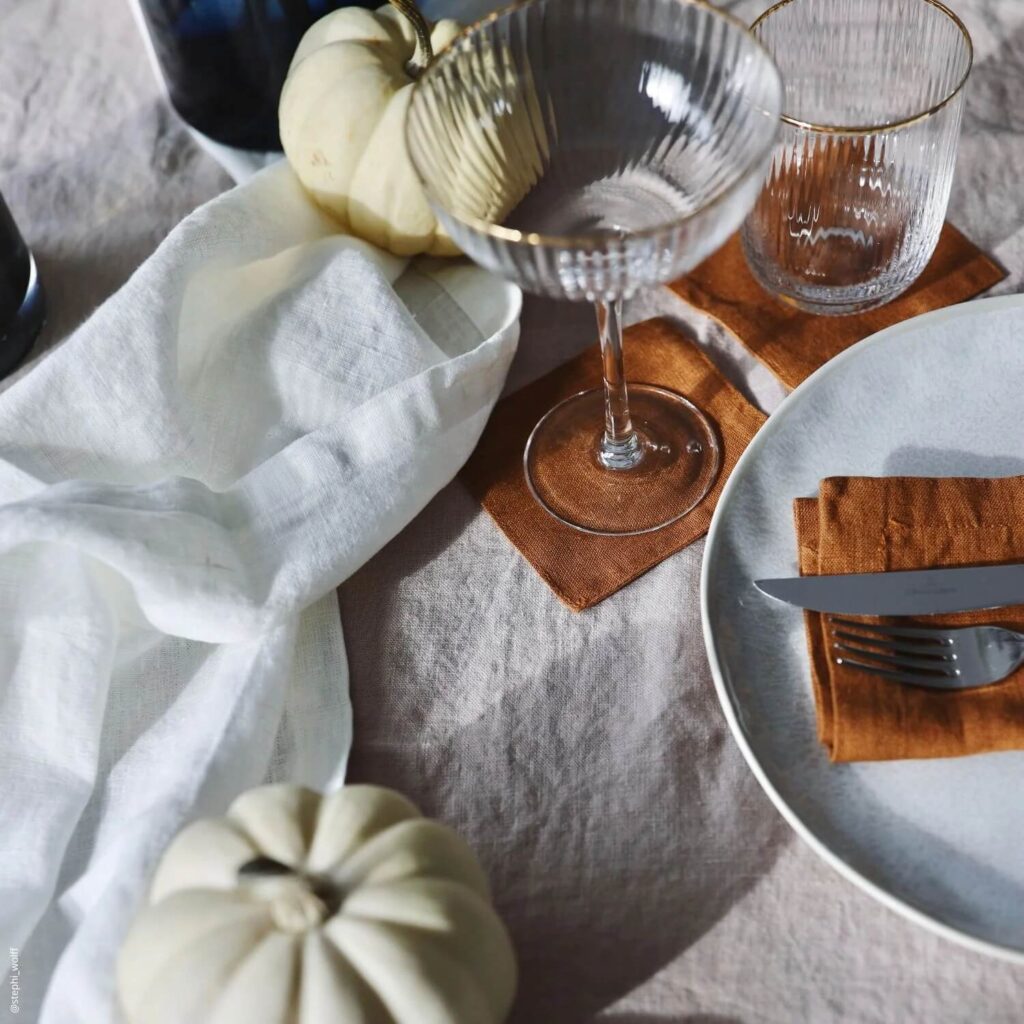 ivory natural linen cocktail napkins next to wine glass