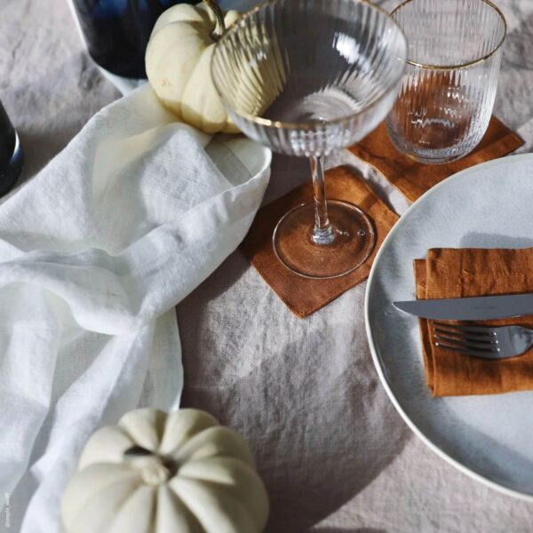 ivory natural linen cocktail napkins next to wine glass