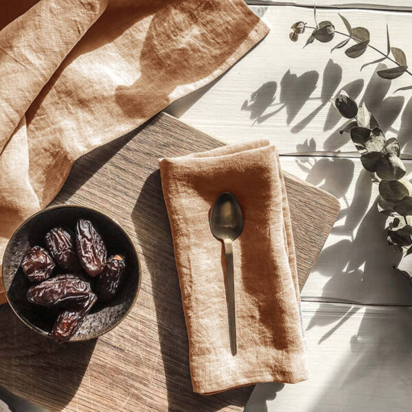 caramel natural linen cocktail napkins on wooden board