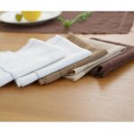 Stack of five cotton linen blend placemats showing all color variations