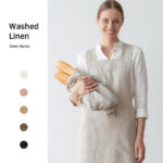 Cotton linen gardening apron in use, model holding bread