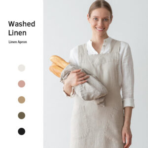 Cotton linen gardening apron in use, model holding bread