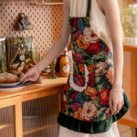 Vintage floral kitchen apron green floral print, close-up of lace pocket detail