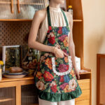 Vintage floral kitchen apron green print, styled in home kitchen setting