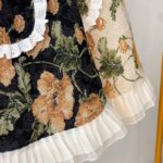 close-up of floral half apron lace trim and print