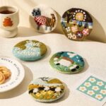 handmade wool felt coasters all 5 designs laid out on a table
