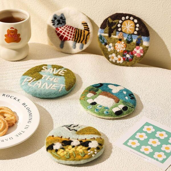 handmade wool felt coasters all 5 designs laid out on a table