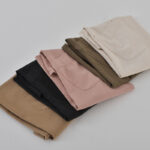 Three colors of cotton linen gardening aprons stacked together