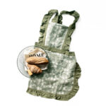 Forest green lace baking cotton apron styled with bread and plate