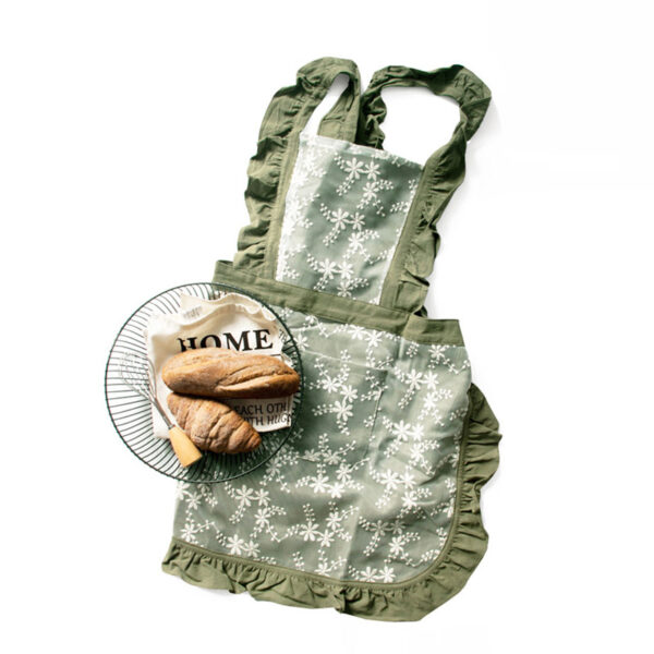 Forest green lace baking cotton apron styled with bread and plate