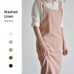 Blush pink cotton linen gardening apron worn by model, front view