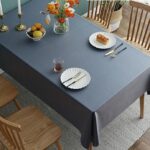 stain resistant tablecloths Waterproof, deep gray cotton linen waterproof tablecloth, minimalist farmhouse dining table setting with tableware and flowers