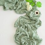 sage green boho polyester table runner crinkled texture on a white background