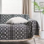 Cat proof bohemian sofa cover black and white badge print, styled living room view