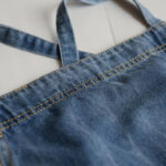 Vintage denim barista apron shoulder strap and fabric detail