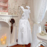 adjustable tie-back waist on white lace cottage apron