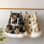two vintage floral half aprons, black and beige styles