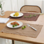 Caramel herringbone cotton linen placemat styled with croissant and lemon for food photography