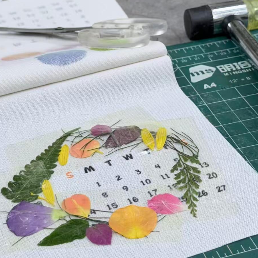DIY botanical pounding process, hammer and fresh leaf layout on linen fabric for eco friendly plant print home textile