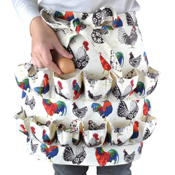 Rooster Print Canvas Egg Collecting Apron hand putting egg into ruffled pocket closeup