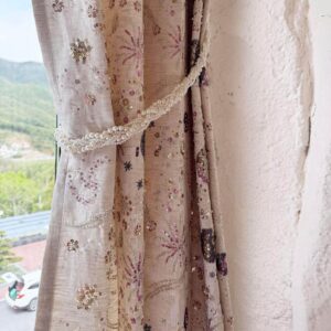 botanical print curtain panel tied back with fabric tieback, beige vintage floral window drapery with gathered side detail