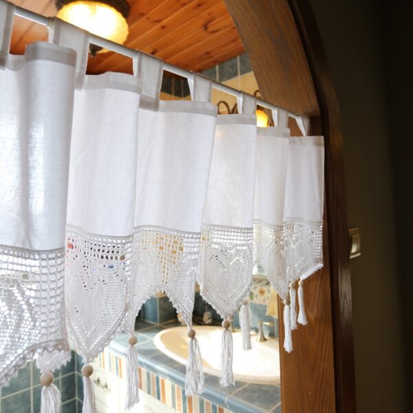 single‑piece white tie top window valance with crochet heart tassels hung on kitchen arch doorway