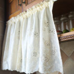 Fresh‑style white floral short curtain decorating wooden kitchen cabinet window
