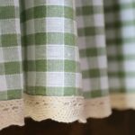 Close‑up of green and white gingham plaid fabric for short window curtain