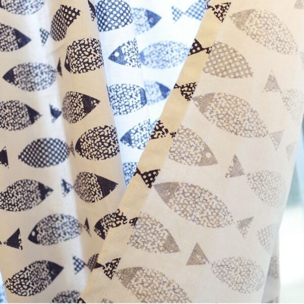 Close‑up of blue fish print fabric texture on 100% cotton farmhouse window curtain
