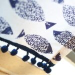 Close‑up of pom‑pom fringe trim on farmhouse blue fish cotton kitchen curtain