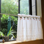 semi‑sheer cottagecore cherry tier curtain hanging by window natural daylight home decor