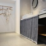 Minimalist grey striped tier curtain applied on indoor storage cabinet