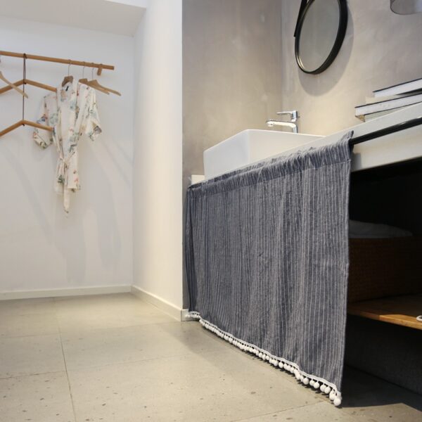 Minimalist grey striped tier curtain applied on indoor storage cabinet