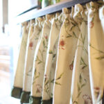 Floral tier curtain hanging on kitchen sink window, farmhouse home decor