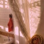 Scalloped edge detail of romantic sheer white lace doorway curtain