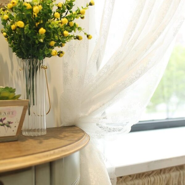 Romantic sheer white lace curtain filters soft natural daylight
