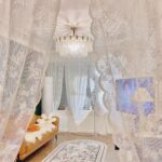 White sheer lace doorway curtain as soft room divider