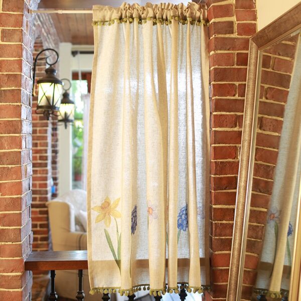 Cottage‑core floral short curtain hung above kitchen sink window, home‑style display