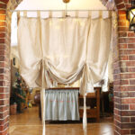 Linen blend woven curtain installed on arched doorway farmhouse home decor