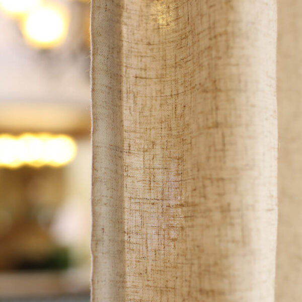 Textured close‑up of woven linen‑blend curtain fabric