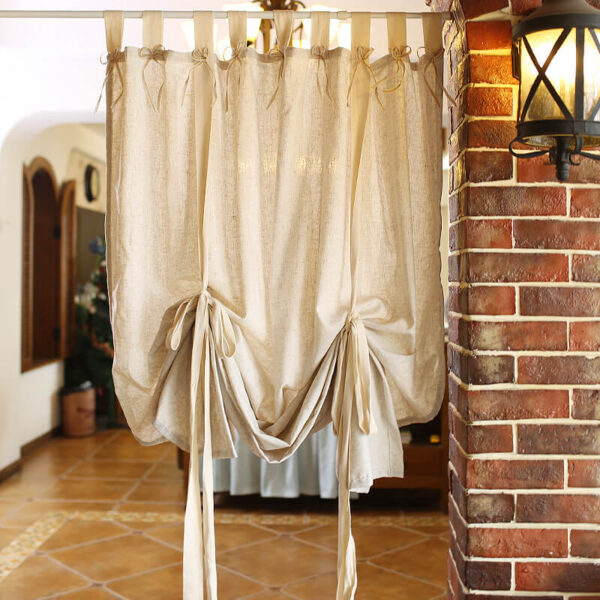 Linen blend woven solid beige curtain hanging on arched farmhouse window