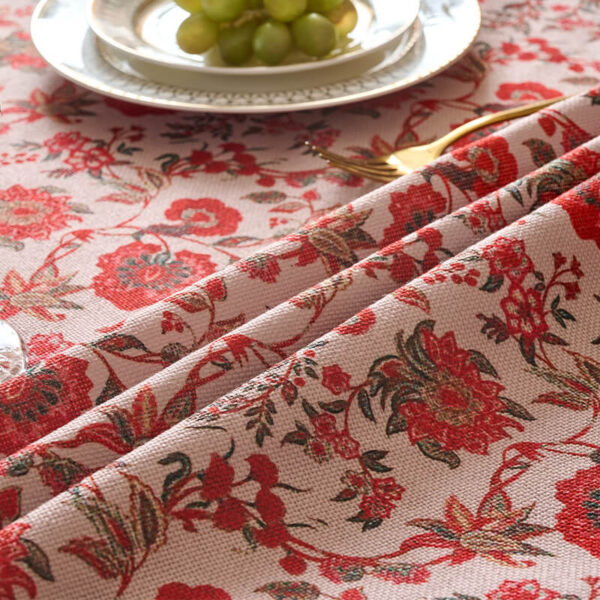Close‑up of intricate red jacobean floral print tablecloth fabric detail