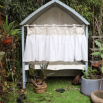 Boho kitchen window curtain hanging on outdoor cottage small window